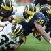 Michigan running back Thomas Rawls reaches a hand out as he's tackled by linebacker Joe Bolden during spring practice at Michigan Stadium on Saturday, April 13, 2013. Melanie Maxwell I AnnArbor.com